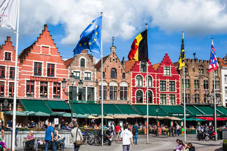 BRUGES, BELGIUM - 26 SEPTEMBER: People relax in the most famous square of Bruges, Grote Markt where  it can find commerce and restaurants. Bruges september 26, 2013のeditorial素材