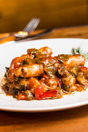 Sausages with sauce and vegetables. Very tasty.の写真素材