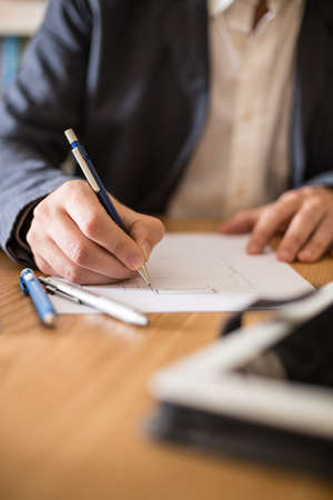 Architect working at his desk drawing a sketch.