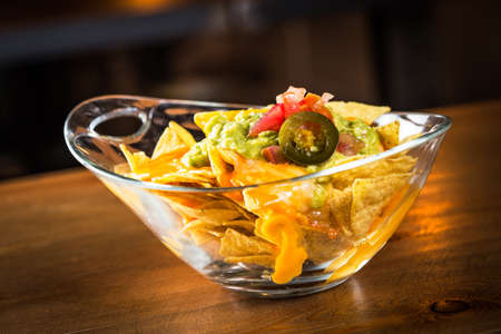 Fresh guacamole with nachos, ready to eat.の写真素材