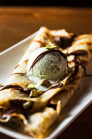 Delicious pistachio ice cream with chocolat crepe.の写真素材