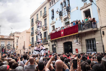BARCELONA, SPAIN - AUGUST 17:  Group of people makes human tower in Festes de Gracia, Barcelona. Catalan human towers are on UNESCO's Cultural Heritage List. August 17, 2014 Barcelona.のeditorial素材