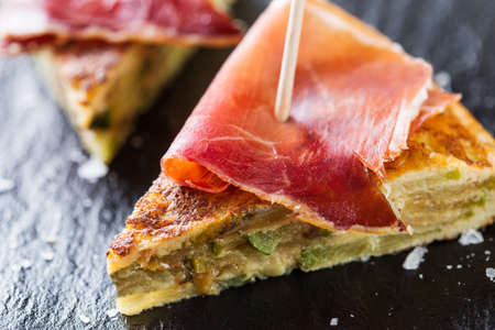 Typical spanish tapas: Tortilla de patatas with serrano ham.の写真素材