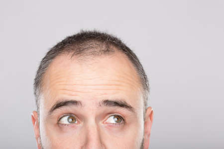 Bearded man with funny expression looking up, sutdio shot.の写真素材