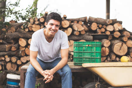 Young lumberjack sitting and smile looking at camera.の写真素材