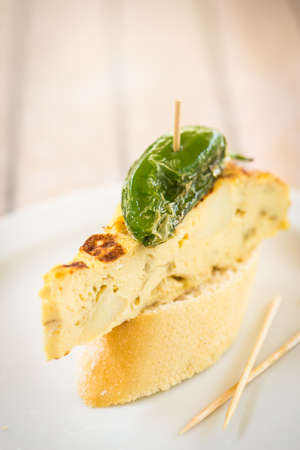 Typical spanish tapas: tortilla de patatas and green pepper.の写真素材