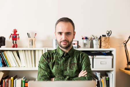 Hipster businessman using laptop in his office.の写真素材