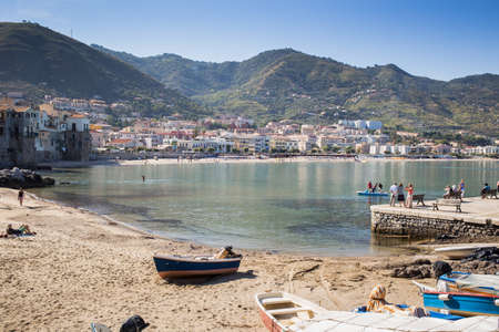 CEFALU - OCTOBER 8: Tourists relax and take sun in Cefalu beach. October 8, 2014 Cefalu, Italy.のeditorial素材