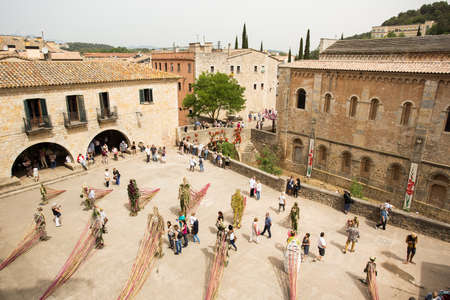 GIRONA - MAY 13: Tourists visit Girona in Temps de Flors that means Flowers time. The old quarter of Girona is garnished with beautiful flowers show. May 13, 2015 Girona, Spain.のeditorial素材