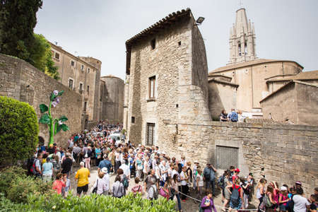 GIRONA - MAY 13: Tourists visit Girona in Temps de Flors that means Flowers time. The old quarter of Girona is garnished with beautiful flowers show. May 13, 2015 Girona, Spain.のeditorial素材