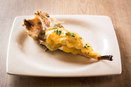 Monkfish tail with gratin garlic and potatoes.