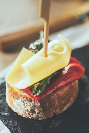 Red and green peppers with cheese, spanish tapas. Vintage edition.の写真素材