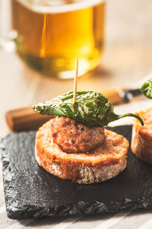 Meatball tapas with green pepper, vertical copy space.の写真素材