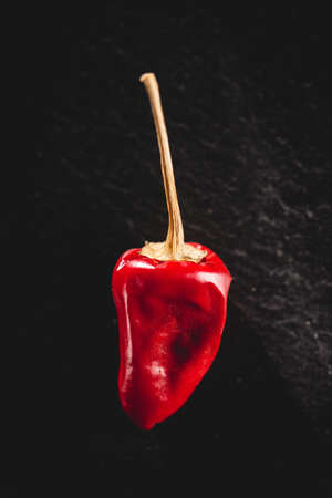 Small red spicy pepper on a dark background. Top view.の写真素材