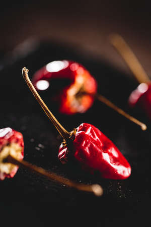 Small red spicy peppers on a dark background.の写真素材