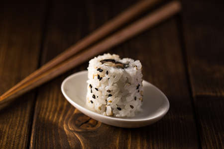 Delicious ebiten maki sushi on a wooden table.の写真素材