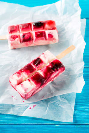 Close-up of delicious ice cream pop on baking paper in daylightの写真素材