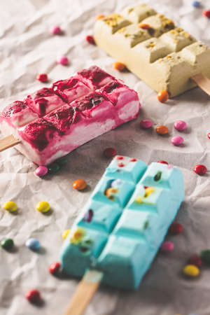 Delicious ice cream pops on with colorful candiesの写真素材