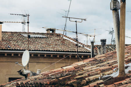 View on tiled roofs with satellitesの写真素材