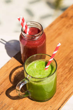 Healthy vegetables juice on a wooden table.