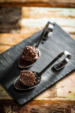 Delicious chocolate truffles on a spoon.の写真素材