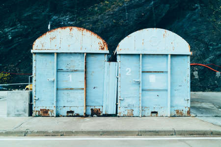View of two iron rusty warehouses in daylightの写真素材