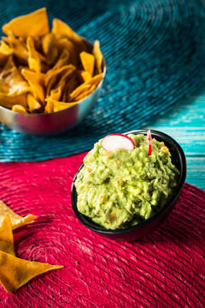 Tasty mexican nachos with fresh guacamole and beer.の写真素材