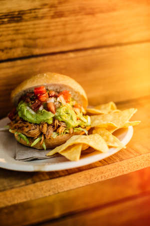 Delicious burger served on plate with nacho chips.の写真素材