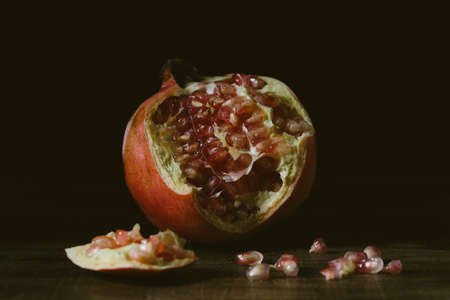 Pictorial fresh pomegranate on dark background.