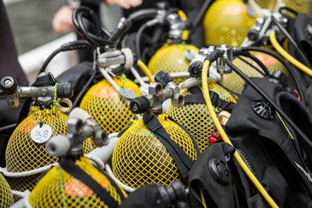 Prepared diving bottles rows with yellow colored net.の写真素材