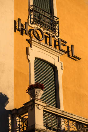 Old hotel sign in a yellow facade.のeditorial素材