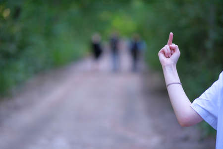 Middle finger up. Social problems, bullying, improper upbringing. An offensive gesture.の写真素材