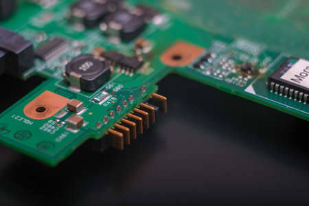 Part of an electronic printed circuit board with many electrical components.の写真素材