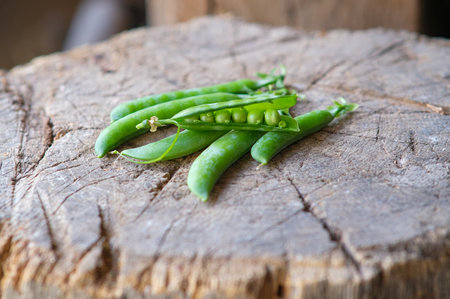 Composition with green peas on a wooden surface.の写真素材