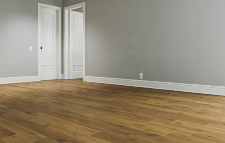 Spacious bright room with wooden floor and white walls.の写真素材
