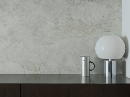 Stylish and minimalist interior with a lamp and a mug on a smooth tableの写真素材