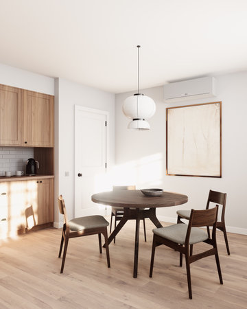 A modern dining room with an elegant round table and wooden chairsの写真素材