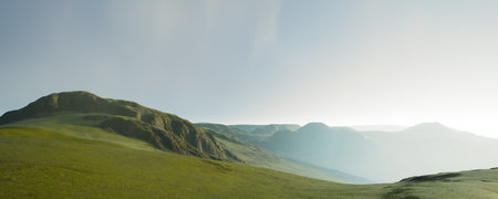 Lush green hills flourish under a bright blue sky filled with beautiful, fluffy cloudsの写真素材