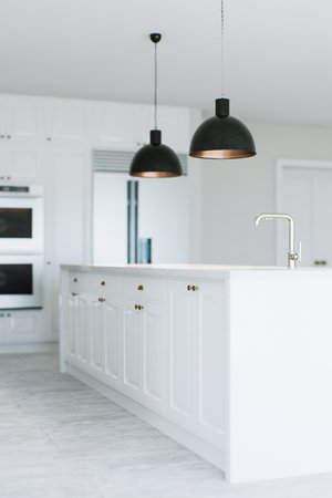 View of the kitchen island in a white kitchen.の写真素材