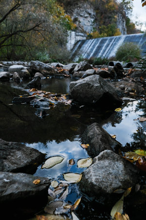 A Serene and Majestic Waterfall Wonderfully Nestled Amidst a Beautifully Vibrant Autumn Landscapeの写真素材