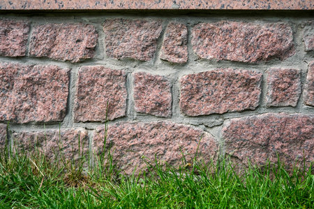 Rustic stone foundation showing textured masonry.の写真素材