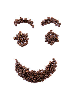 Smiley face made of coffee beans on white backgroud with copyspaceの写真素材