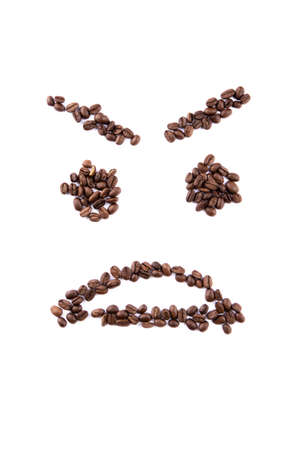 Smiley face made of coffee beans on white backgroud with copyspaceの写真素材
