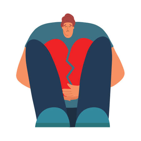 Sad man sits with a broken heart shape in his hands. Breaking up a relationship with a girl. The guy is worried about love experiences. Vector illustration in flat styleのイラスト素材