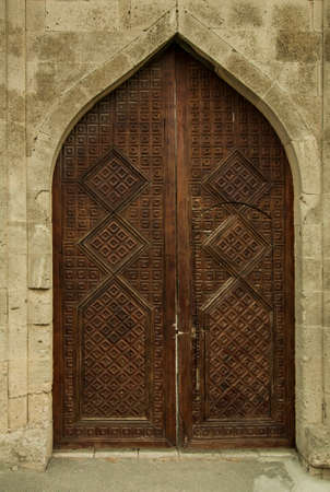 Ancient wooden door in the museum Shirvanshakhs Baku Azerbaijanのeditorial素材