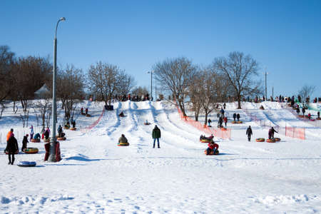 Sledding hill with a day off in the estate of Kolomenskoe ye, Moscow, Russia, February 24, 2013