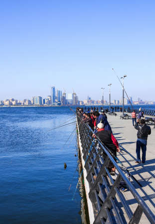 Seaside Park, Baku, Azerbaijan - April 17, 2017. A group of anglers are fishing in the Caspian Sea from the pier.のeditorial素材