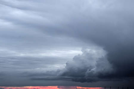 Storm clouds at sunset in a larger view. Rain is on the horizon.の写真素材
