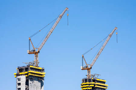 Cranes manufacturing construction work. Close-up panorama City,の写真素材
