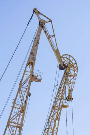 Large port cranes against a blue sky. Close-up of the construction elements of the crane.の写真素材